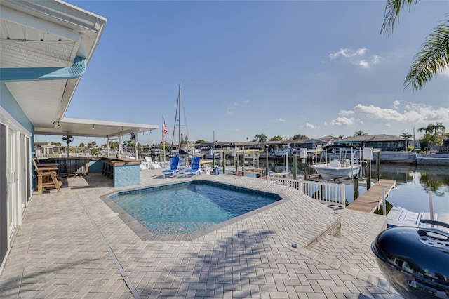 view of pool featuring boat lift, a boat dock, and a water view