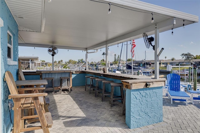 view of patio / terrace with a water view and a bar