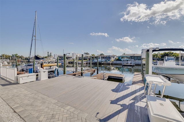 view of dock with boat lift and a water view