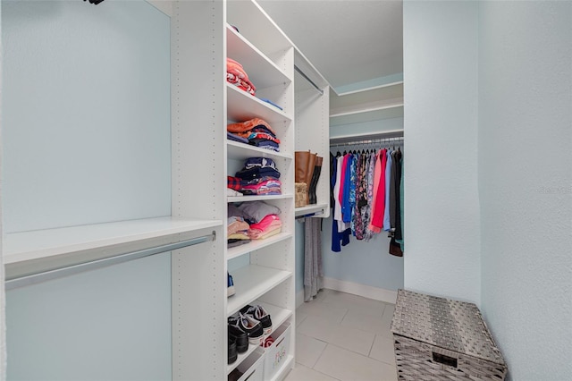 spacious closet with light tile patterned floors