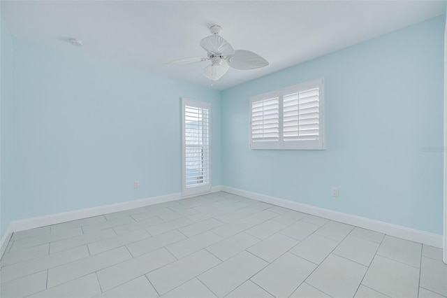 unfurnished room featuring a ceiling fan and baseboards