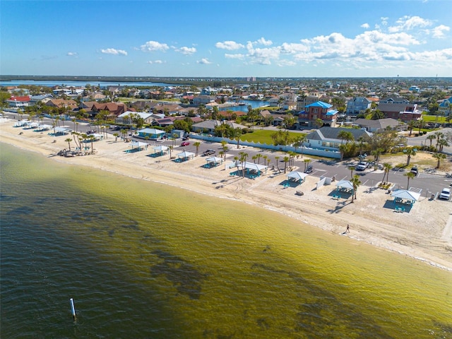 drone / aerial view with a residential view, a view of the beach, and a water view