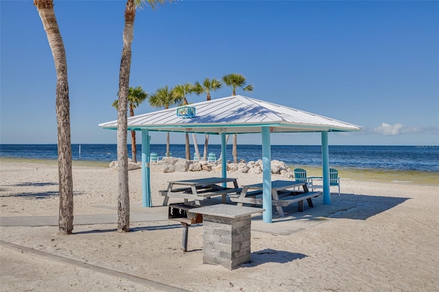 surrounding community featuring a gazebo, a beach view, and a water view