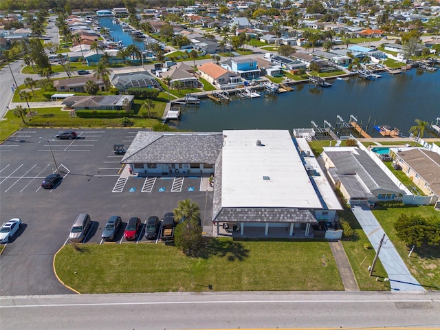 drone / aerial view featuring a water view and a residential view