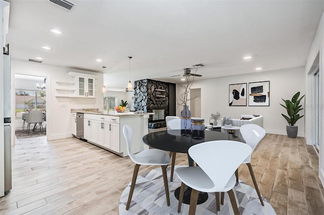 dining space with light wood finished floors, visible vents, recessed lighting, and a ceiling fan