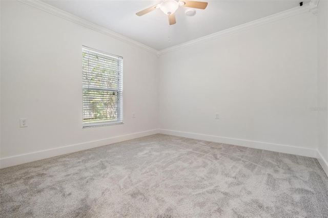 unfurnished room with carpet flooring, baseboards, ceiling fan, and ornamental molding