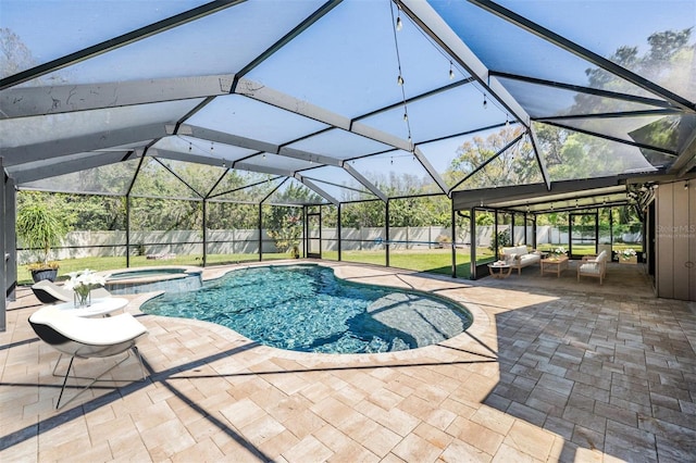 view of swimming pool featuring a patio, a fenced backyard, a pool with connected hot tub, and a lanai