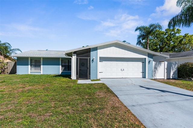 view of front facade with an attached garage, driveway, a front lawn, and fence