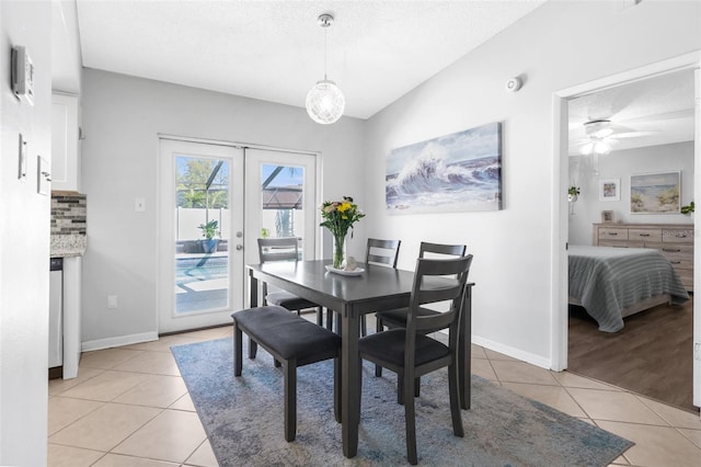 dining space featuring a ceiling fan, a textured ceiling, french doors, light tile patterned floors, and baseboards