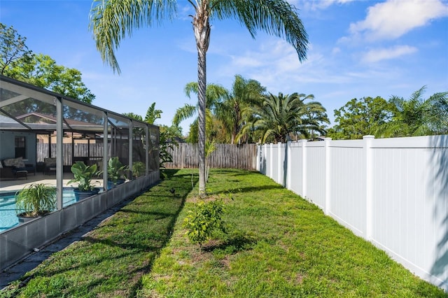 view of yard with a fenced in pool, a fenced backyard, a lanai, a patio area, and an outdoor hangout area