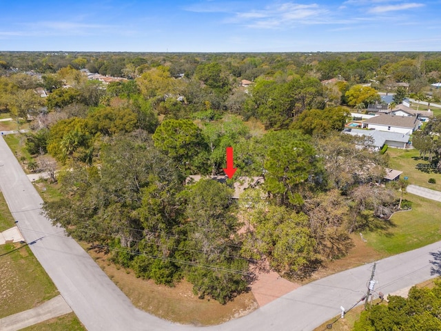 drone / aerial view with a wooded view