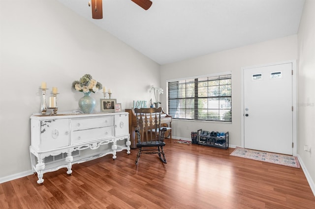 interior space featuring wood finished floors, baseboards, and ceiling fan