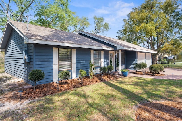 single story home featuring an attached garage, roof with shingles, and a front lawn