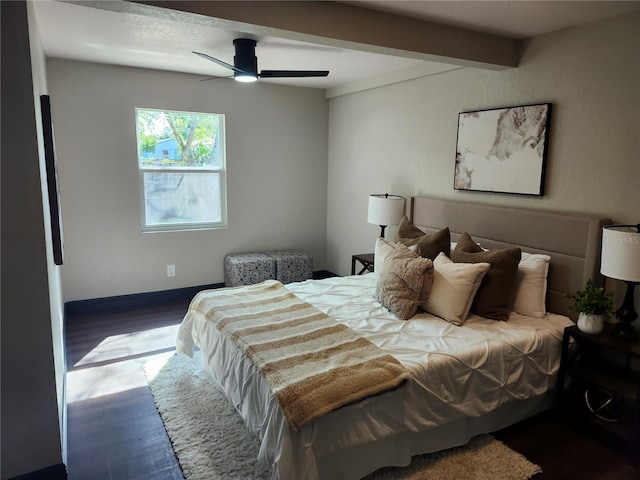 bedroom featuring beam ceiling, wood finished floors, and a ceiling fan