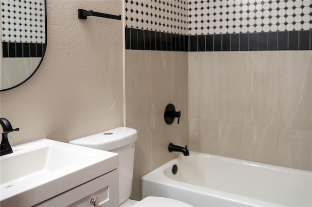 full bathroom with vanity, toilet, bathing tub / shower combination, and a textured wall