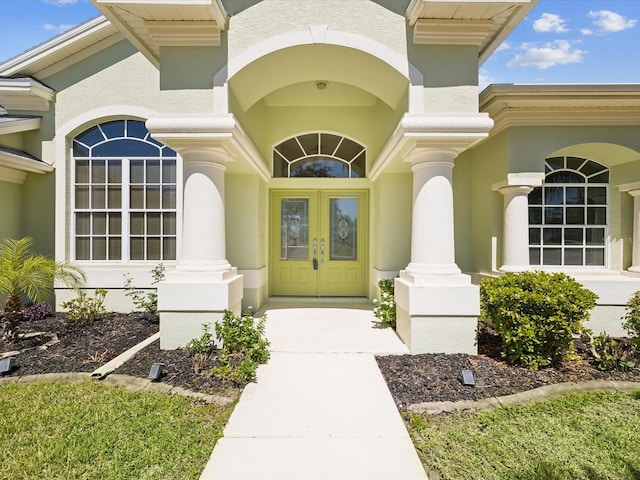 entrance to property with stucco siding and french doors