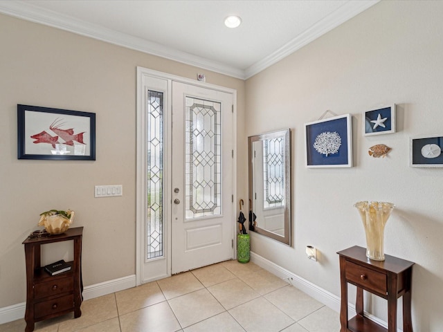 foyer featuring crown molding, light tile patterned floors, and baseboards