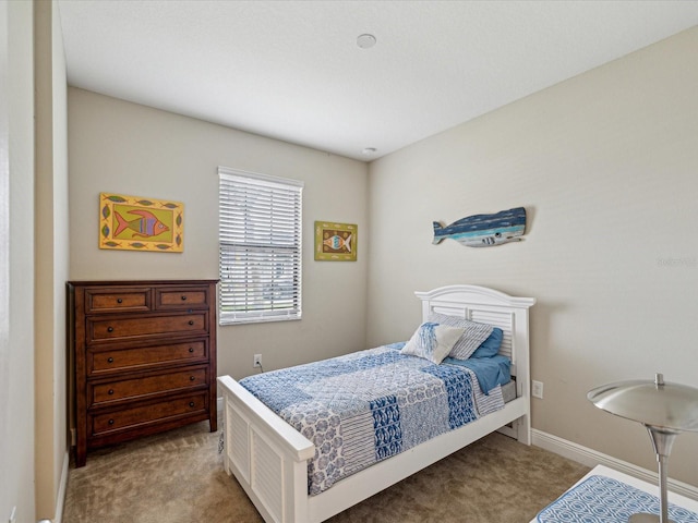 carpeted bedroom featuring baseboards