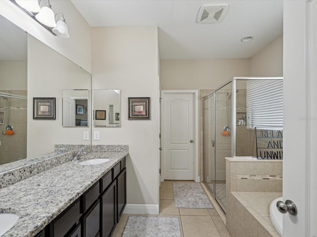 bathroom with a sink, a shower stall, and tile patterned flooring