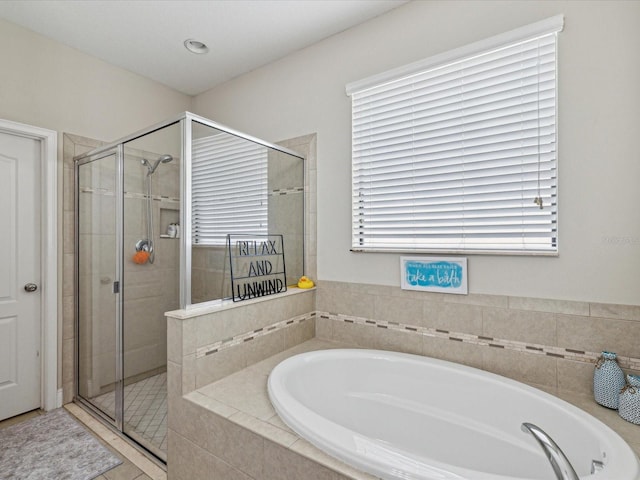 full bath with a garden tub and a shower stall