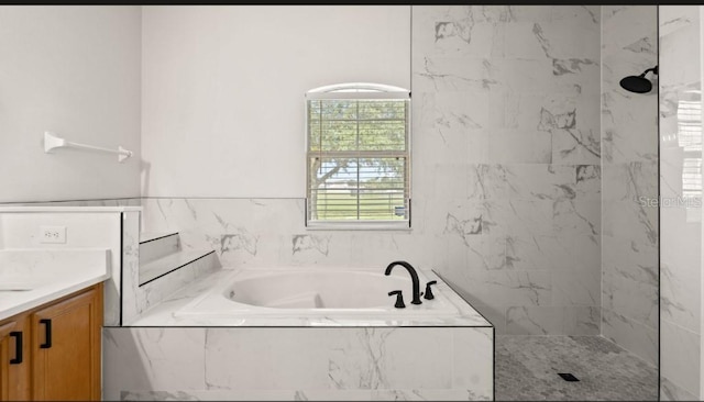 bathroom featuring vanity, a bath, and a marble finish shower