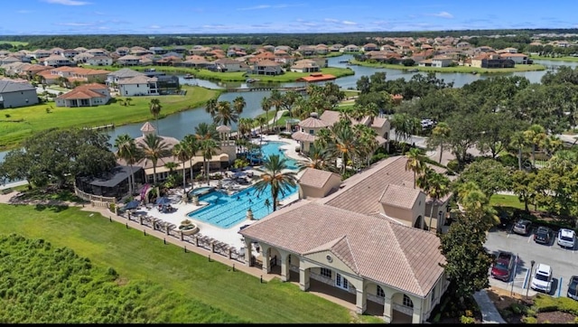 drone / aerial view featuring a residential view and a water view