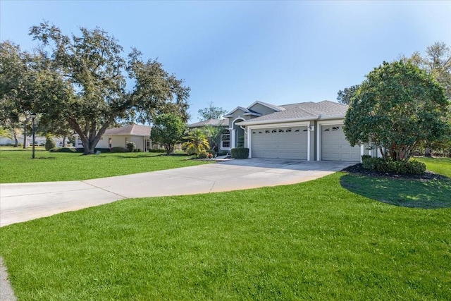 view of front of home featuring an attached garage, concrete driveway, and a front lawn