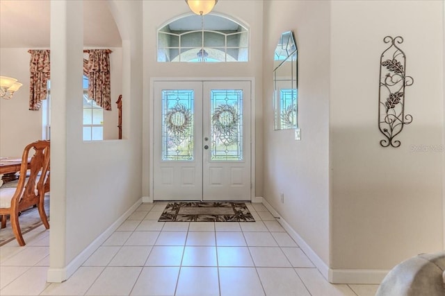 entrance foyer with light tile patterned floors and baseboards