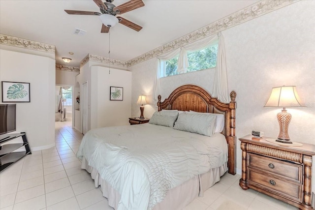 bedroom with visible vents, multiple windows, baseboards, and connected bathroom