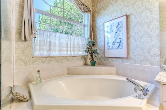 bathroom featuring wallpapered walls, a bath, and vanity