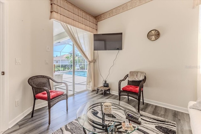 living area featuring wood finished floors and baseboards