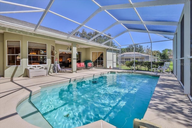 pool featuring a lanai and a patio area