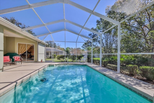 pool with a patio area and glass enclosure