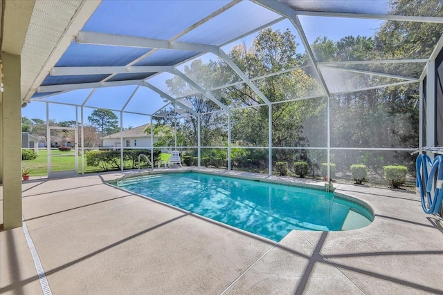 pool with glass enclosure and a patio