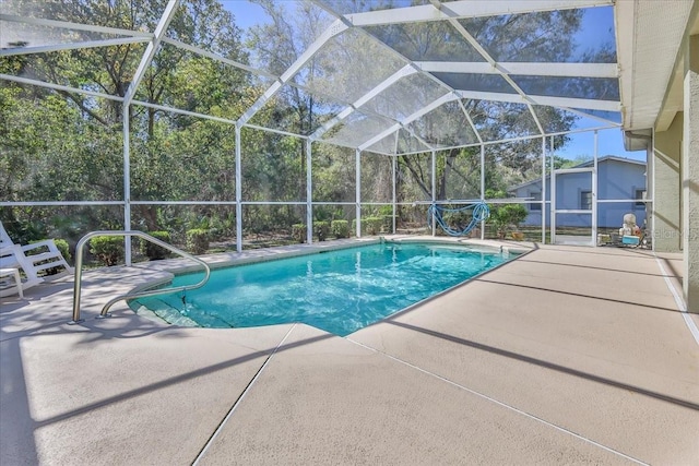 outdoor pool featuring a lanai and a patio area