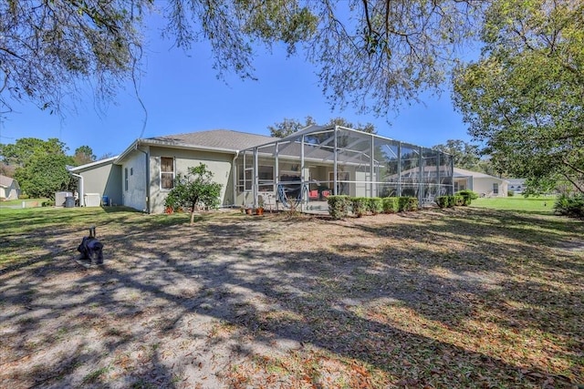 back of property featuring stucco siding and a lanai