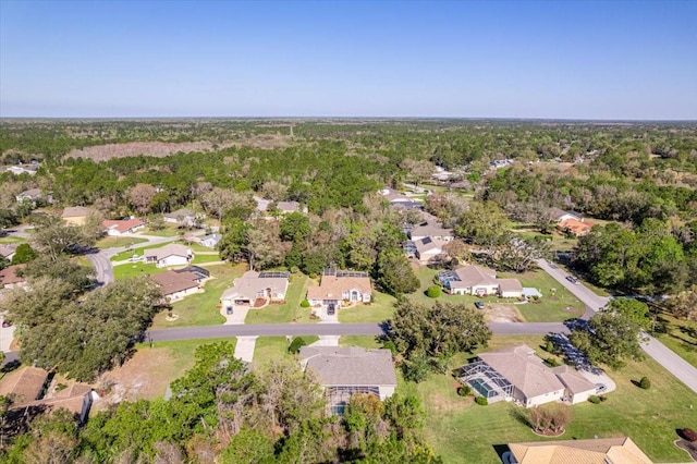 birds eye view of property with a residential view and a wooded view