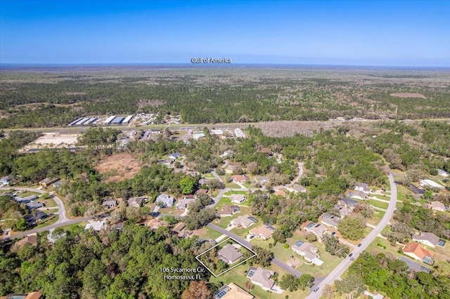 birds eye view of property with a wooded view