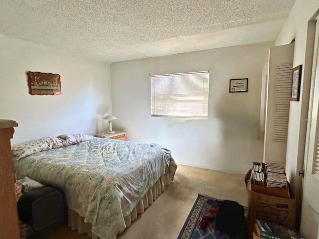 bedroom with a textured ceiling and carpet floors