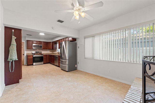 kitchen with visible vents, appliances with stainless steel finishes, light countertops, baseboards, and ceiling fan