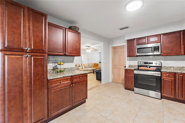 kitchen with visible vents, tasteful backsplash, appliances with stainless steel finishes, light tile patterned floors, and dark brown cabinets