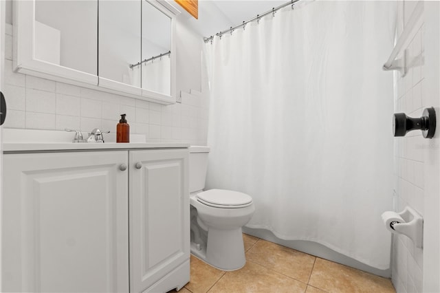 full bathroom with tile patterned floors, toilet, tasteful backsplash, tile walls, and vanity