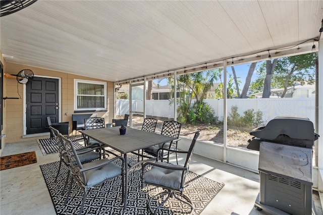 sunroom featuring vaulted ceiling