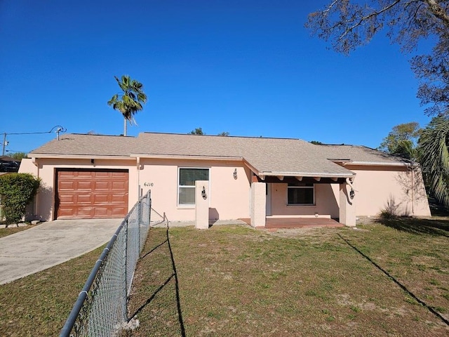 exterior space with an attached garage, fence, driveway, and stucco siding