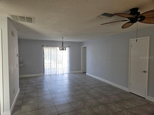 tiled empty room with visible vents, baseboards, a textured ceiling, and ceiling fan with notable chandelier