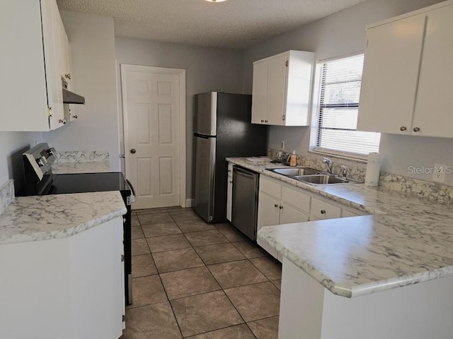 kitchen with under cabinet range hood, white cabinets, appliances with stainless steel finishes, and a sink