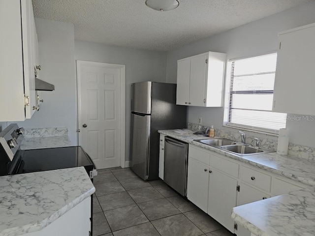 kitchen with a sink, light countertops, white cabinets, appliances with stainless steel finishes, and exhaust hood