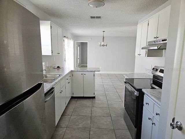 kitchen featuring visible vents, under cabinet range hood, appliances with stainless steel finishes, a peninsula, and white cabinets