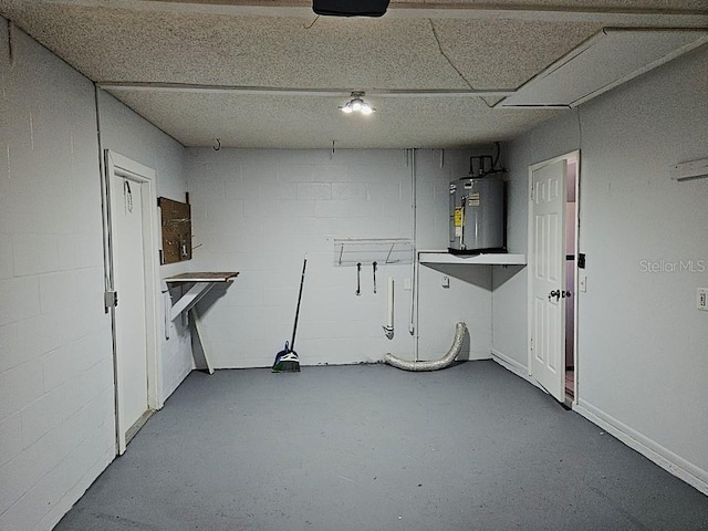 interior space featuring concrete block wall and water heater