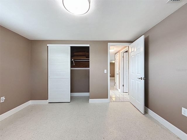 unfurnished bedroom featuring a closet, visible vents, and baseboards